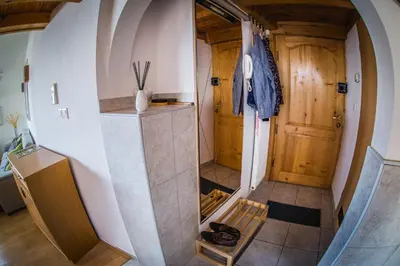 a room with a hallway with a wooden door at Top Apartments - Dunin Wąsowicza in Kraków