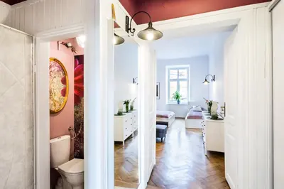 a living room with white walls and a red ceiling at Apartment Bernardynska in Kraków