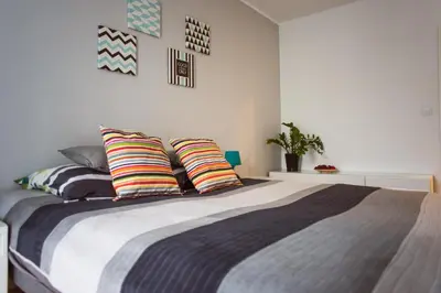a bedroom with a large bed with colorful pillows at Przy Mocaku in Kraków