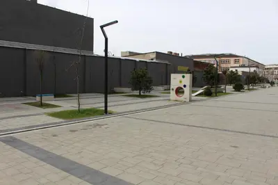 an empty street with a building and a street light at Przy Mocaku in Kraków