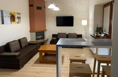 a living room with a couch and a table at Apartament Bielany Kraków in Kraków