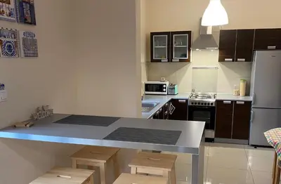 a kitchen with a counter top and a refrigerator at Apartament Bielany Kraków in Kraków