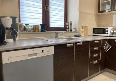 a kitchen with a sink and a microwave at Apartament Bielany Kraków in Kraków
