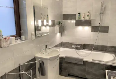 a bathroom with a sink and a bath tub at Apartament Bielany Kraków in Kraków