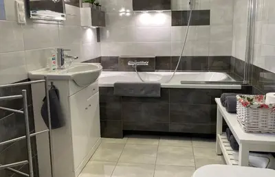 a bathroom with a sink and a bath tub at Apartament Bielany Kraków in Kraków