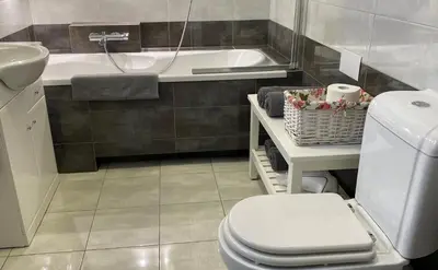 a bathroom with a toilet and a sink and a tub at Apartament Bielany Kraków in Kraków
