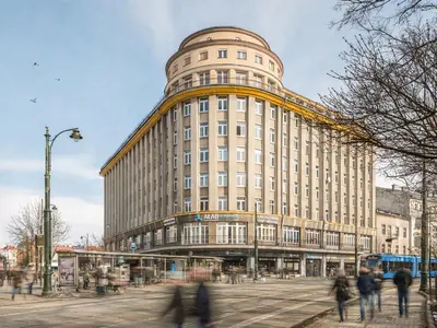 a large building with people walking in front of it at Fragola Apartments Old Town in Kraków