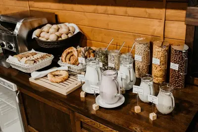 a counter with a bunch of food on a table at Zulian Aparthotel by Artery Hotels in Kraków