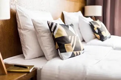 two white pillows on a bed in a hotel room at Zulian Aparthotel by Artery Hotels in Kraków