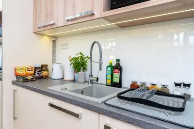 a kitchen counter with a sink in a kitchen at Apartament Mateo Inn in Kraków