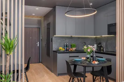 a kitchen and dining room with a table and chairs at Apartament Mateo Inn in Kraków
