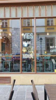 a store window with a sign in the window at Apartment Łobzowska in Kraków