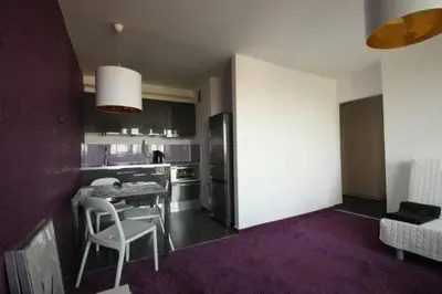 a kitchen with a table and chairs in a room at Apartment Łobzowska in Kraków