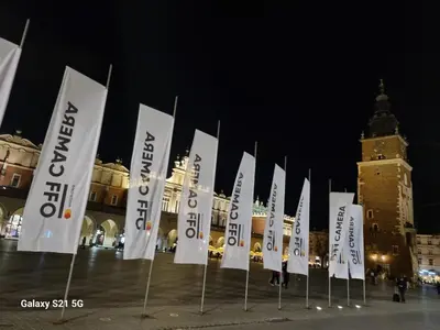 a row of white flags in front of a building at Apartment Łobzowska in Kraków