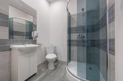 a bathroom with a toilet and a sink and a mirror at 70s Guest room in Kraków