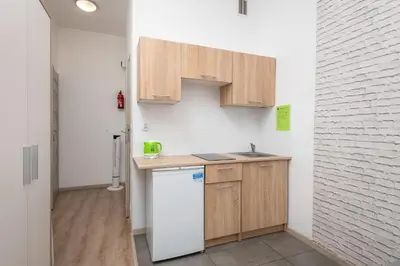 a bedroom with a bed and a couch and a window at 70s Guest room in Kraków