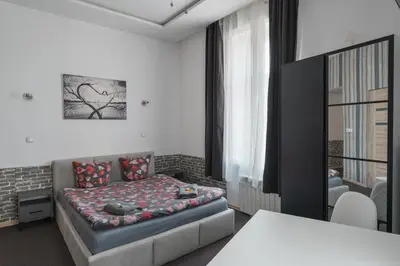 a bedroom with a bed with pillows on it at 70s Guest room in Kraków