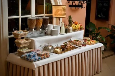a buffet with food and drinks on a table at Hotel Polski Pod Białym Orłem in Kraków
