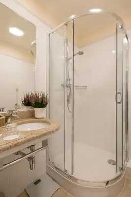 a bathroom with a shower and a sink at Hotel Polski Pod Białym Orłem in Kraków