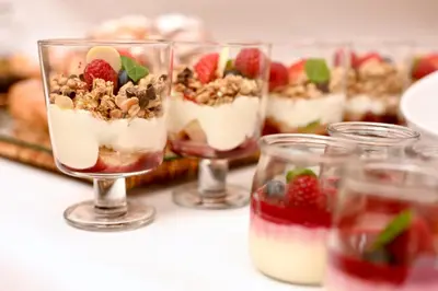a row of glasses filled with desserts on a table at Hotel Polski Pod Białym Orłem in Kraków