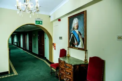 a hallway with a painting of a man on the wall at Hotel Polski Pod Białym Orłem in Kraków