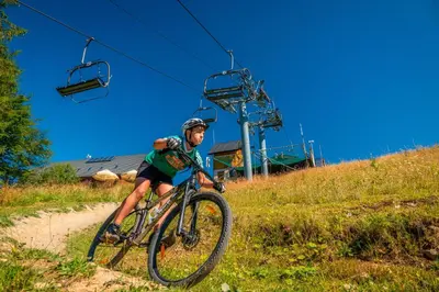 a man riding a bike down a rocky trail at Siedlisko Babia Góra in Zawoja