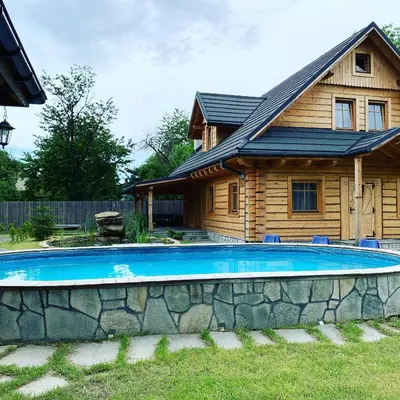 a house with a swimming pool in front of a house at Gniazdko Pod Lipą in Andrychów