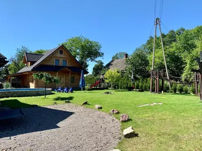 a yard with a house and a playground at Gniazdko Pod Lipą in Andrychów