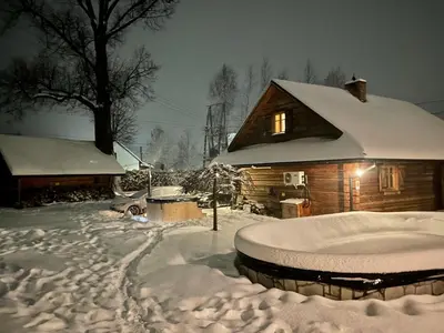 a house covered in snow in front at Gniazdko Pod Lipą in Andrychów