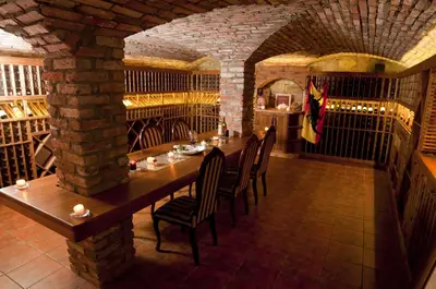 a dining room with a table in a wine cellar at Folwark Stara Winiarnia in Mszana Dolna