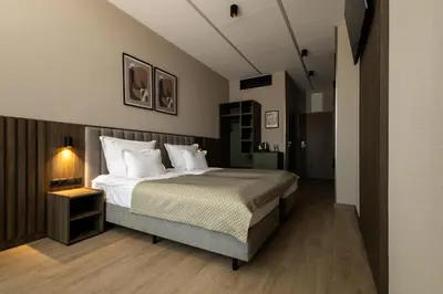 a bedroom with a large bed with white pillows at Hotel Centrum Business in Kraków