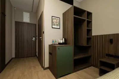 a hallway with a room with a closet and a refrigerator at Hotel Centrum Business in Kraków