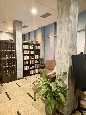 a living room with a couch and a plant at Hotel Centrum Business in Kraków