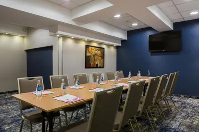 a conference room with a long table and chairs at Hotel Centrum Business in Kraków