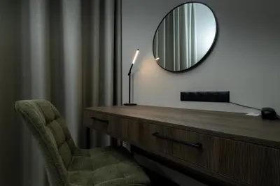 a room with a desk with a mirror and a chair at Hotel Centrum Business in Kraków