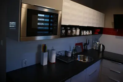 a kitchen counter with a sink and a microwave at Friendly Apartments - Krakow in Kraków