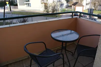 a balcony with two chairs and a table and a table and chairs at Friendly Apartments - Krakow in Kraków