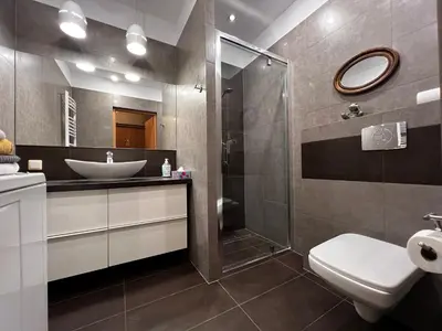 a bathroom with a sink and a toilet and a shower at Friendly Apartments - Krakow in Kraków