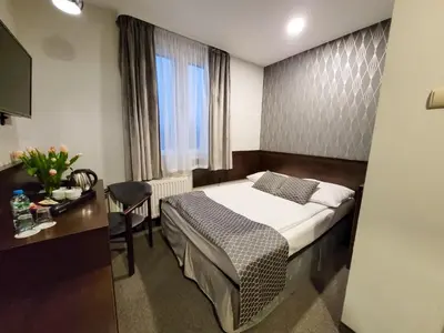 a room with a bunch of beds and chairs at Hotel Fero Express POKOJE KLIMATYZOWANE AC in Kraków