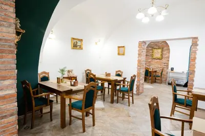 a dining room with wooden tables and chairs at Pokoje Gościnne Dom św. Szymona in Kraków