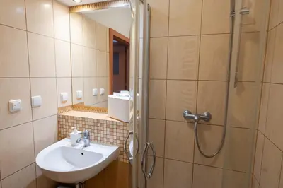 a bathroom with a sink and a shower at Pokoje Gościnne Dom św. Szymona in Kraków