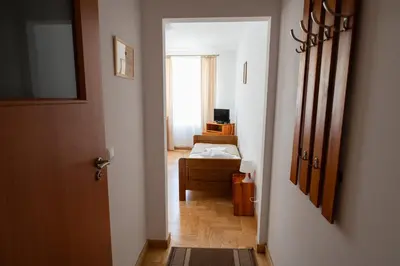 a hallway with a room with a bed and a door at Pokoje Gościnne Dom św. Szymona in Kraków