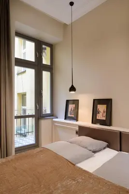 a bedroom with two beds and a window at apartament PAULOVE in Kraków