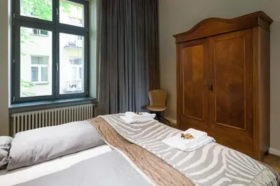 a bedroom with a bed with two towels on it at apartament PAULOVE in Kraków