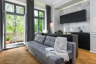 a living room with a couch and a tv at apartament PAULOVE in Kraków