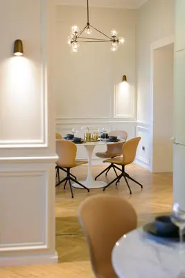 a dining room with a table and chairs at apartament PAULOVE in Kraków