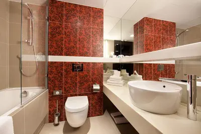 a bathroom with a sink and a toilet and a tub at Niebieski Art Hotel & Spa in Kraków
