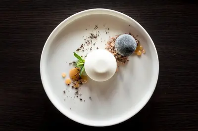 a white plate with some food on a table at Niebieski Art Hotel & Spa in Kraków