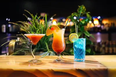 two cocktails sitting on a table in a bar at Niebieski Art Hotel & Spa in Kraków