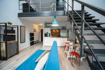 a loft with a slide in the middle of a room at Kazimierz Friendhouse Apartments in Kraków